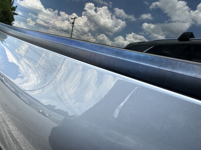 Iridescent blue discoloration running the full length of the black anodized roof trim on a Tesla Model Y