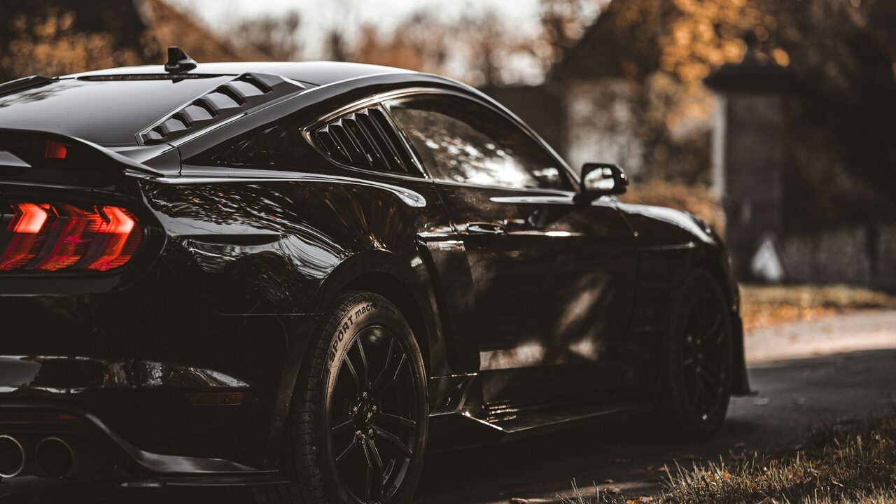 A glossy, freshly detailed black car — the kind of before-and-after result that wins local Charlotte customers
